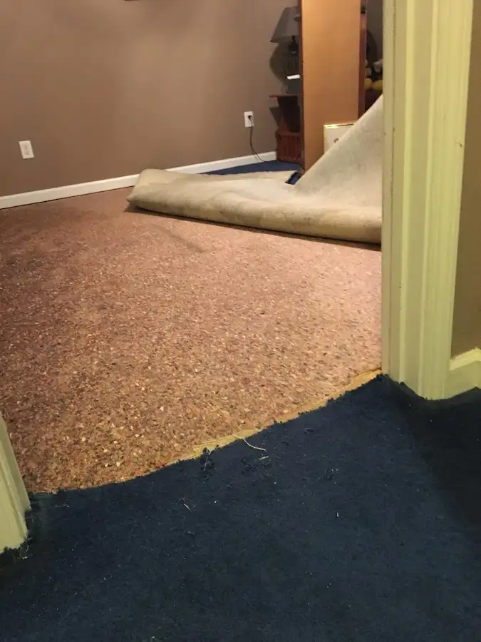 Carpet pad removal revealing water damage during Drying & Dehumidification in Artesia